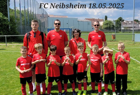 Fünf Jungen in roten Shirts stehen zusammen und lächeln für ein Gruppenfoto.